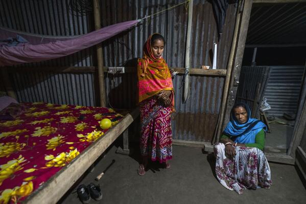 Radha Rani Mondal, 50, right, with her daughter in law Mampi Biswash sit in their shanty home in Morigaon district of Indian northeastern state of Assam, Friday, Feb. 10, 2023. Mondal's 20-year-old son was arrested on Feb. 4 and her 17-year-old daughter-in-law is pregnant. She spent her last 500 rupees ($6 ) to hire a lawyer, whom she owes 20,000 rupees ($ 250 ) more. More than 3,000 men, including Hindu and Muslim priests, who were arrested nearly two weeks ago in the northeastern state of Assam under a wide crackdown on illegal child marriages involving girls under the age of 18. (AP Photo/Anupam Nath)