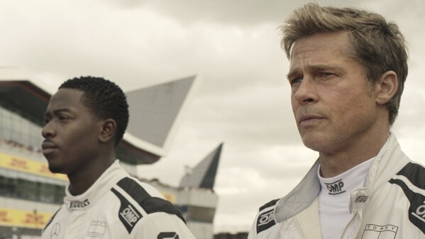 This image released by Warner Bros. Pictures shows Damson Idris, left, and Brad Pitt in a scene from "F1." (Warner Bros. Pictures via AP)