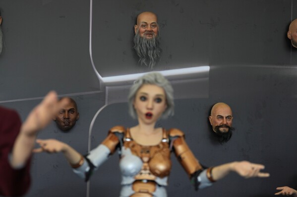 Human like robots and robotic faces that mimic human expressions are displayed at the annual World Robot Conference at the Beijing Etrong International Exhibition and Convention Center in Beijing, Wednesday, Aug. 16, 2023. (AP Photo/Ng Han Guan)