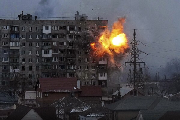 FILE - An explosion erupts from an apartment building after a Russian army tank fired on it in Mariupol, Ukraine, March 11, 2022. The image is part of the documentary "20 Days in Mariupol." (AP Photo/Evgeniy Maloletka)