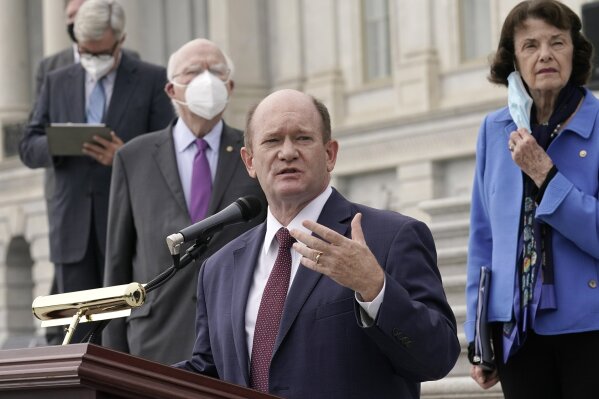 Sen. Chris Coons, D-Del., speaks during a news conference after boycotting the vote by the Republican-led panel to advance the nomination of Judge Amy Coney Barrett to sit on the Supreme Court, Thursday, Oct. 22, 2020, at the Capitol in Washington, as other Democratic committee members look on. (AP Photo/J. Scott Applewhite)
