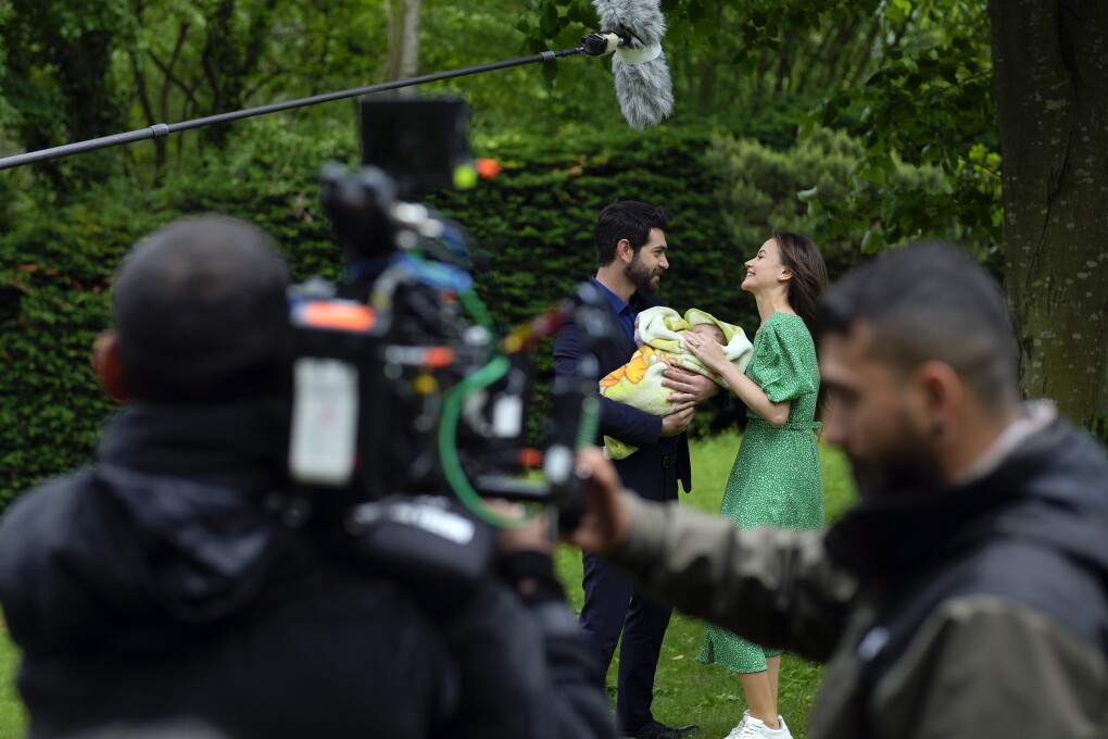 A production team is filming scenes of a Turkish drama with actor Paris Baktas and actress Yagmur Yuksel, Turkey, Tuesday, April 30, 2024. Turkey has emerged as a leading exporter of television drama, bolstering the nation’s international image and drawing millions of viewers and tourists worldwide to its historical and cultural sites which are backdrops to many of the shows. (AP Photo/Khalil Hamra)