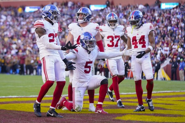 New York Giants linebacker Kayvon Thibodeaux (5) and teammates celebrate a fumble recovery against the Washington Commanders during the second half of an NFL football game, Sunday, Nov. 19, 2023, in Landover, Md. (AP Photo/Andrew Harnik)