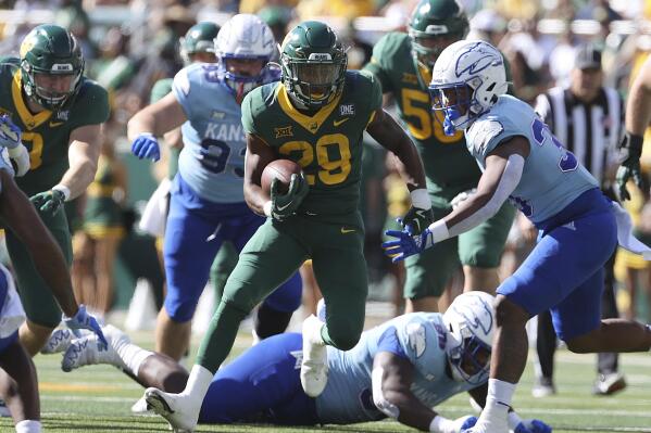 Baylor running back Richard Reese runs through the Kansas defense in the first half of an NCAA college football game, Saturday, Oct. 22, 2022, in Waco, Texas. (AP Photo/Jerry Larson)