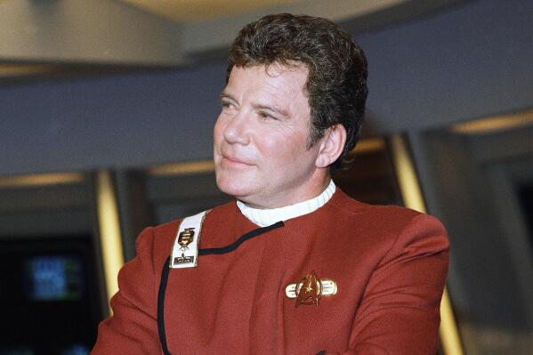 FILE - In this 1988 file photo, William Shatner, who portrays Capt. James T. Kirk, attends a photo opportunity for the film "Star Trek V: The Final Frontier." The performer who breathed life into Kirk is, at age 90, heading toward the stars under dramatically different circumstances than his fictional counterpart when Shatner boards Jeff Bezos' Blue Origin NS-18. (AP Photo/Bob Galbraith, File)