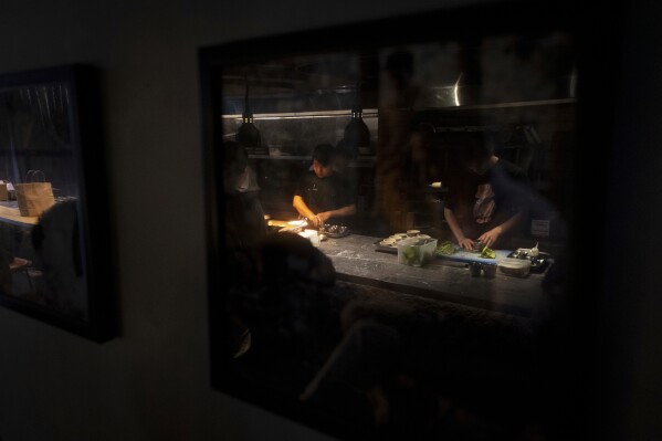 Dishes made with fish sauce are prepared at Chapter Dining, a fine dining restaurant, on March 1, 2025, in Hanoi, Vietnam. (AP Photo/Yannick Peterhans)