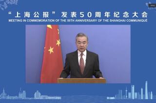 In this image made from video, Chinese Foreign Minister Wang Yi delivers an address during a forum marking the 50th anniversary of the Shanghai Communique signed during the icebreaking 1972 visit to China by President Richard Nixon in Shanghai, Monday, Feb. 28, 2022. China's top diplomat called on the U.S. Monday to take steps to improve ties, as tensions simmer over Taiwan, trade and other issues. (Chinese People's Association for Friendship with Foreign Countries via AP)