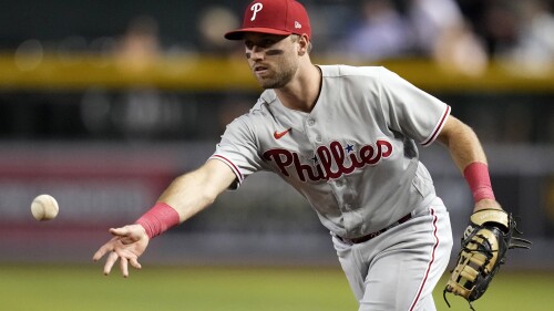 Philadelphia Phillies first baseman Kody Clemens tosses the ball to the pitcher covering first base for the out on Arizona Diamondbacks' Pavin Smith during the fourth inning of a baseball game Tuesday, June 13, 2023, in Phoenix. (AP Photo/Ross D. Franklin)