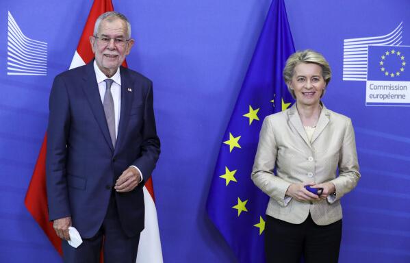 European Commission President Ursula von der Leyen, right, welcomes Austrian President Alexander Van der Bellen at EU headquarters in Brussels, Tuesday, July 13, 2021. (Pascal Rossignol, Pool Photo via AP)