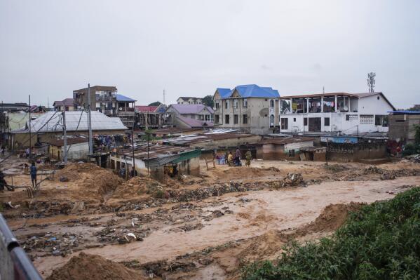 Areas are damaged following torrential rains in Kinshasa, Democratic Republic of Congo, Tuesday, Dec. 13, 2022. At least 100 people have been killed and dozens injured by widespread floods and landslides caused by the rains. (AP Photo/Samy Ntumba Shambuyi)