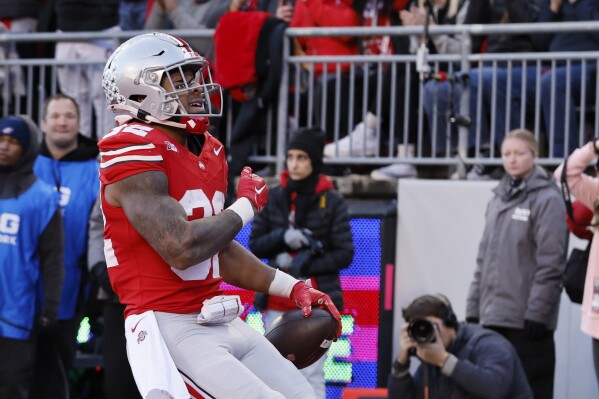 Ohio State running back TreVeyon Henderson celebrates after his touchdown against Minnesota during the first half of an NCAA college football game Saturday, Nov. 18, 2023, in Columbus, Ohio. (AP Photo/Jay LaPrete)