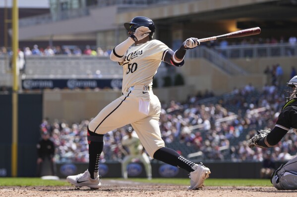 Minnesota Twins' Willi Castro (50) hits an RBI-single during the sixth inning of a baseball game against the Chicago White Sox, Thursday, April 25, 2024, in Minneapolis. (AP Photo/Abbie Parr)