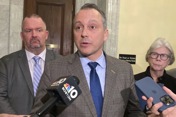 Democratic state Rep. Aaron Michlewitz discusses a bill that would limit how long individuals can stay in state shelters as the system strains under an influx of homeless migrants, Wednesday, March 6, 2024, in Boston. Under the bill, the state would limit the maximum stay to nine months with an additional three months for those employed or enrolled in a job training program. (AP Photo/Steve LeBlanc)