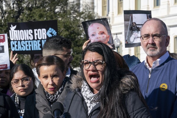 FILE - Rep. Rashida Tlaib, D-Mich., the only Palestinian-American in Congress, is joined at left by Rep. Nydia Velazquez, D-N.Y., as she speaks at an event to call for a cease fire by Israel in Gaza, at the Capitol in Washington, Dec. 14, 2023. A group of progressive lawmakers are fighting back against a multi-million dollar campaign to push them out of Congress for their vocal opposition to Israel's deadly bombardment of Gaza after the Oct. 7 attack. (AP Photo/J. Scott Applewhite, File)