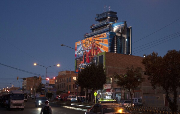 The architectural attraction 'Cruise of the Andes', decorated with symbols of the Tiwanakota and Inca cultures, towers over El Alto, Bolivia, Friday, Sept. 8, 2023. Architect Freddy Mamami is the creator of the building popularly known as a cholet, a term that combines the words cholo and chalet. (AP Photo/Juan Karita)