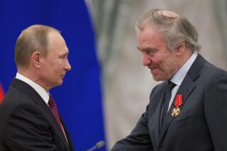 FILE - Russian President Vladimir Putin, left, presents a medal to then Mariinsky Theatre's Artistic Director Valery Gergiev, during an awarding ceremony in Moscow's Kremlin, Russia, Thursday, Sept. 22, 2016. Munich's mayor says Valery Gergiev has been fired as chief conductor of the Munich Philharmonic because of his support for Russian President Vladimir Putin and for not rejecting the invasion of Ukraine. (AP Photo/Ivan Sekretarev, pool,file)