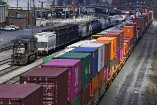 FILE - This April 2, 2021, file photo shows freight train cars and containers at Norfolk Southern Railroad's Conway Yard in Conway, Pa. Railroad engineers accepted their deal with the railroads that will deliver 24% raises but conductors rejected the contract casting more doubt on whether the industry will be able to resolve the labor dispute before next month’s deadline without Congress’ help. The votes, Monday, Nov. 21, 2022, by the two biggest railroad unions follows the decision by three other unions to reject their deals with the railroads that the Biden administration helped broker before the original strike deadline in September. (AP Photo/Gene J. Puskar, File)