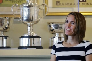 FILE - Justine Henin, of Belgium, speaks during an interview at the International Tennis Hall of Fame, Saturday, July 16, 2016, in Newport, R.I. prior to her induction. The International Tennis Federation has awarded Justine Henin its highest honor, the Philippe Chatrier Award. Henin won seven Grand Slam singles titles, an Olympic gold medal, and was part of Belgium’s team that won the Fed Cup — now called the Billie Jean King Cup — in 2001. (AP Photo/Elise Amendola, File)