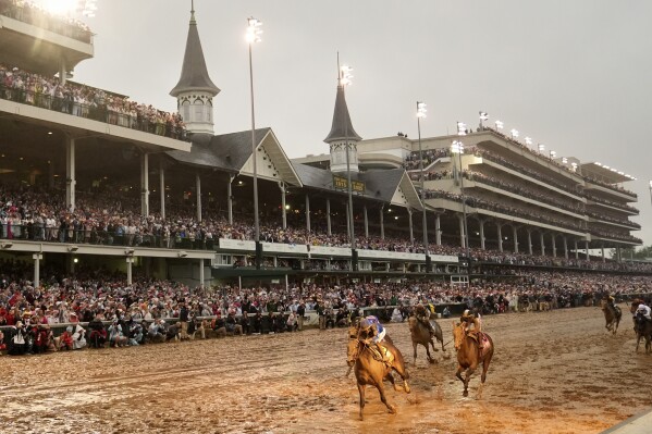 Sovereignty, left, ridden by Junior Alvarado, crosses the finish line to win the 151st running of the Kentucky Derby horse race at Churchill Downs Saturday, May 3, 2025, in Louisville, Ky. (AP Photo/Abbie Parr)
