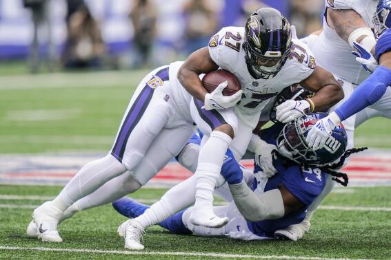 New York Giants linebacker Jaylon Smith (54) tackles Baltimore Ravens running back J.K. Dobbins (27) during the first half of an NFL football game Sunday, Oct. 16, 2022, in East Rutherford, N.J. (AP Photo/John Minchillo)