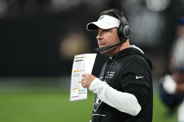 Las Vegas Raiders head coach Josh McDaniels walks on the sideline during the second half of an NFL football game against the Los Angeles Chargers, Sunday, Dec. 4, 2022, in Las Vegas. (AP Photo/Matt York)