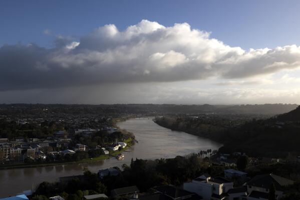 The Whanganui River winds through the town of Whanganui, New Zealand, on June 15, 2022. In 2017, New Zealand passed a groundbreaking law granting personhood status to the river. The law declares that the river is a living whole, from the mountains to the sea, incorporating all its physical and metaphysical elements. (AP Photo/Brett Phibbs)