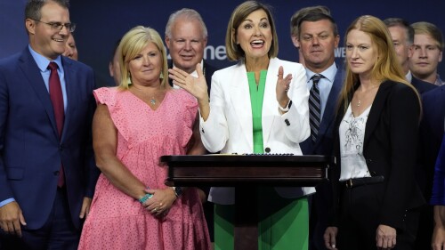 FILE - Iowa Gov. Kim Reynolds reacts after signing a new law banning abortions after six weeks of pregnancy before speaking at the Family Leadership Summit, Friday, July 14, 2023, in Des Moines, Iowa. (AP Photo/Charlie Neibergall, File)