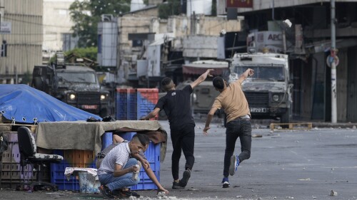 Palestinians clash with Israeli security forces during a military raid in the West Bank city of Nablus, Friday, July 7, 2023. Palestinian health officials say two Palestinians were killed Friday by Israeli fire in the occupied West Bank, days after Israel concluded a major two-day offensive meant to crack down on militants. (AP Photo/Majdi Mohammed)