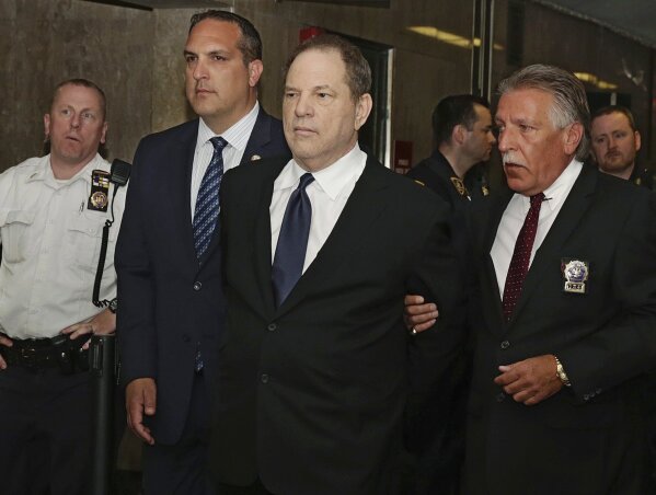 
              FILE - In this July 9, 2018 file photo, Harvey Weinstein is escorted in handcuffs to a courtroom in New York. Weinstein, who was previously indicted on charges involving two women, w...