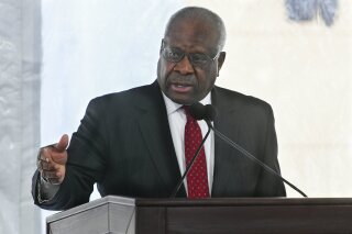 FILE - In this Feb. 11, 2020, file photo, Supreme Court Justice Clarence Thomas delivers a keynote speech during a dedication of Georgia new Nathan Deal Judicial Center in Atlanta. A Supreme Court justice gets it in his mind to ask a question, and pretty soon, he's got questions for everyone. And so the next question: Will Clarence Thomas ever stop talking? Before this week, the intervals between Thomas' questions during high court arguments were measured in years. He once went 10 years, from 2006 to 2016, without asking even one.  (AP Photo/John Amis, File)