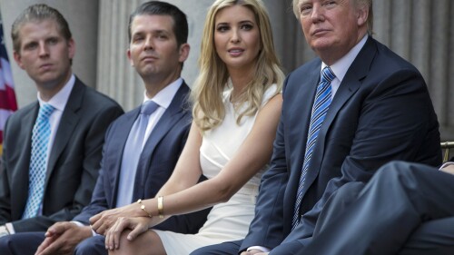 FILE - Donald Trump, right, sits with his children, from left, Eric Trump, Donald Trump Jr., and Ivanka Trump during a groundbreaking ceremony for the Trump International Hotel on July 23, 2014, in Washington. A New York appeals court dismissed Ivanka Trump on Tuesday, June 27, 2023, from a wide-ranging fraud lawsuit brought against her father and his company last year by the state's attorney general. (AP Photo/Evan Vucci, File)