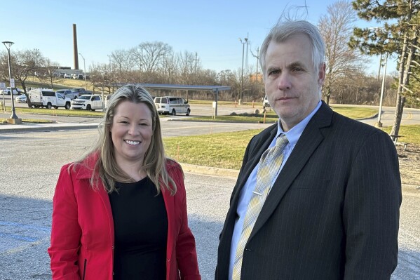 Stefanie Lambert, left, and her attorney, Daniel J. Hartman, stand outside the Oakland County Jail in Pontiac, Mich, after she posted bond Thursday evening, March 21, 2024. Lambert turned herself in Thursday morning after having been arrested in Washington, D.C. earlier this week as a result of a bench warrant issued by a Michigan judge. Lambert is facing felony charges of improperly accessing voting equipment in a search for evidence of a conspiracy to steal the 2020 election from Trump. (AP Photo/Corey Williams)