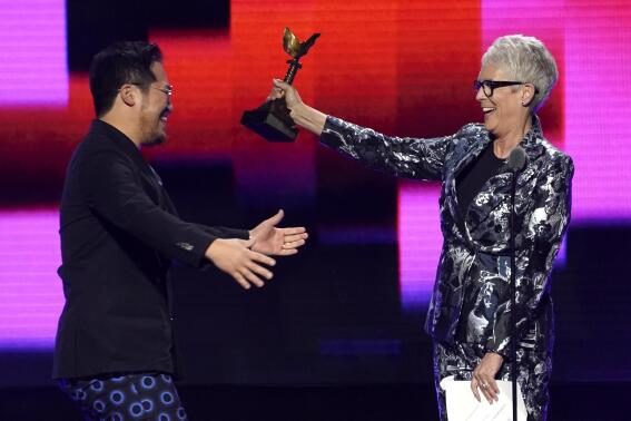 Jamie Lee Curtis, right, presents Daniel Kwan with the award for best screenplay for "Everything Everywhere All at Once" at the Film Independent Spirit Awards on Saturday, March 4, 2023, in Santa Monica, Calif. (AP Photo/Chris Pizzello)