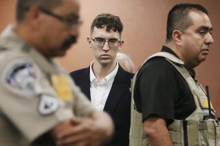 FILE - In this Oct. 10, 2019 file photo, El Paso Walmart shooting suspect Patrick Crusius pleads not guilty during his arraignment in El Paso, Texas. Crusius attorneys said in a court filing that he has "severe, lifelong neurological and mental disabilities.” They say the 21-year-old and was treated with anti-psychotic medication following his arrest moments after the massacre in El Paso that killed 23.  (Briana Sanchez/El Paso Times via AP, Pool, File)