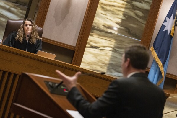 Minnesota Supreme Court Associate Justice Theodora Karin Gaïtas, left, listens as Nicholas Nelson, an attorney representing Republican House leadership, responds to her question during oral arguments at the Minnesota Judicial Center in St. Paul, Minn., Thursday, Jan. 23, 2025. (Ben Hovland/Minnesota Public Radio via AP, Pool)