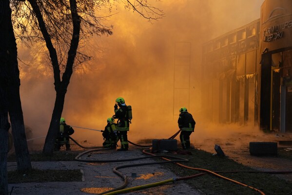 Firefighters work to extinguish a fire in a destroyed building after a Russian attack in Kyiv, Ukraine, Tuesday, Jan. 2, 2024. (AP Photo/Efrem Lukatsky)