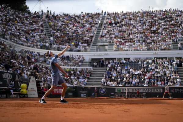 Alexanders Zverev, of Germany, left, serves to Nicolas Jarry, of Chile, during the Italian Open tennis tournament final match at Rome's Foro Italico, Sunday, May 19, 2024. (AP Photo/Alessandra Tarantino)