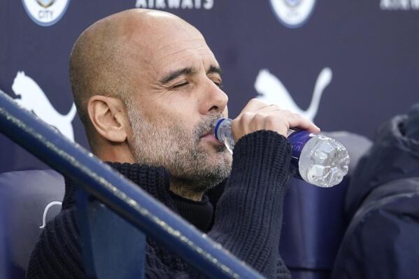 Manchester City's head coach Pep Guardiola drinks a water ahead the English Premier League soccer match between Manchester City and West Ham United at Etihad stadium in Manchester, England, Wednesday, May 3, 2023. (AP Photo/Dave Thompson)