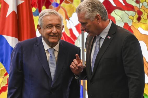 FILE - Cuban President Miguel Diaz Canel, right, and Mexico's President Andrés Manuel López Obrador speak after signing bilateral agreements at Revolution Palace in Havana, Cuba, May 8, 2022. Díaz-Canel will be awarded Mexico's highest medal when he visits the southern Mexican city of Campeche on Feb. 11, 2023, according to the Mexican government's official gazette. (Yamil Lage/Pool Photo via AP, File)