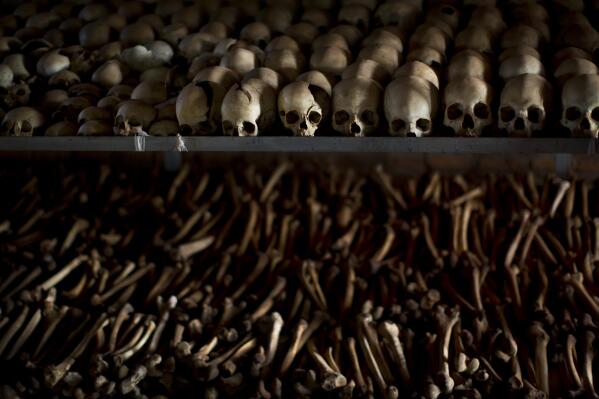 FILE - The skulls and bones of some of those who were slaughtered as they sought refuge inside the church are laid out as a memorial to the thousands who were killed in and around the Catholic church during the 1994 genocide in Ntarama, Rwanda, on April 4, 2014. Rwanda on Thursday, April 7, 2022 commemorated the 28th anniversary of the country's descent into an orgy of violence in which some 800,000 Tutsis and moderate Hutus were massacred by the majority Hutu population over a 100-day period in what was the worst genocide in recent history. (AP Photo/Ben Curtis, File)