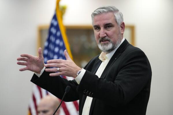 Indiana Gov. Eric Holcomb presents his proposed state spending plan during an announcement in Indianapolis, Wednesday, Jan. 4, 2023. Holcomb's proposal comes as the Republican-dominated Legislature is set to start its 2023 session on Monday, with its primary business being the adoption of a new two-year state budget. (AP Photo/Michael Conroy)