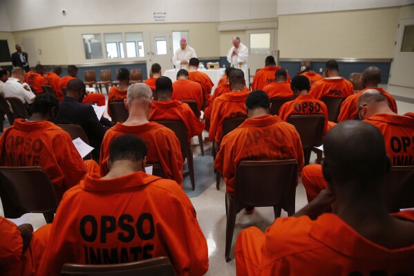 The Archbishop of New Orleans, Gregory Aymond, will run a holy prayer service at Orleans Parish Prison Chaplain Pater Terry Hayden, right, in the Orleans Justice Center in New Orleans. (AP Photo/Gerald Herbert, file)