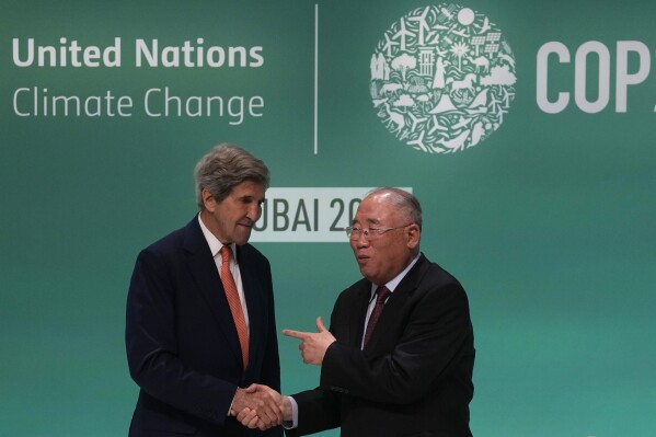 FILE - John Kerry, U.S. Special Presidential Envoy for Climate, left, and Xie Zhenhua, China special envoy for climate, meet for a news conference at the COP28 U.N. Climate Summit, Dec. 13, 2023, in Dubai, United Arab Emirates. Kerry feels he’s going out on a high note as he retires from leading U.S. efforts in international negotiations to confront ever-worsening climate change. (AP Photo/Rafiq Maqbool, File)