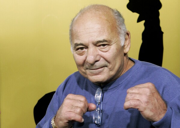 Burt Young, a cast member of the film "Rocky Balboa," gestures at the premiere of the film in Los Angeles, Dec. 13, 2006. Burt Young, the Oscar-nominated actor who played Paulie, the rough-hewn, mumbling-and-grumbling best friend, corner-man and brother-in-law to Sylvester Stallone in the “Rocky” franchise, has died. Young died Oct. 8, 2023 in Los Angeles. 
