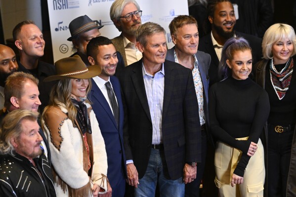 Tennessee Governor Bill Lee, center, poses with legislative leadership, artists, songwriters, and others, during a news conference at RCA Records announcing new legislation designed to protect songwriters, performers and other music industry professionals against the potential dangers of artificial intelligence, Wednesday, Jan. 10, 2024 in Nashville, Tenn. (APPhoto/John Amis)
