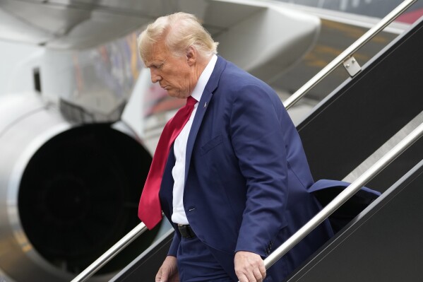 Former President Donald Trump arrives at Ronald Reagan Washington National Airport, Thursday, Aug. 3, 2023, in Arlington, Va., as he heads to Washington to face a judge on federal conspiracy charges alleging Trump conspired to subvert the 2020 election. (AP Photo/Alex Brandon)