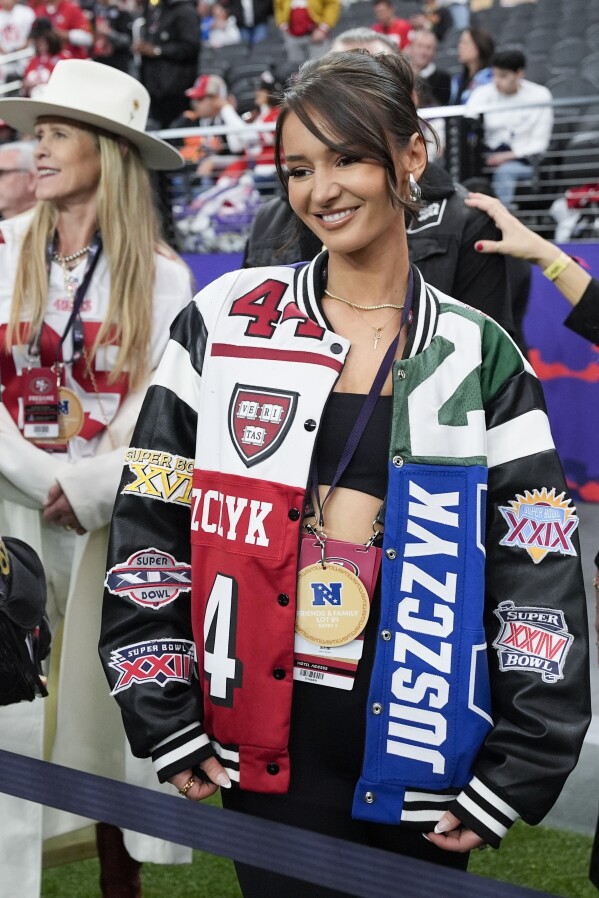 FILE - Kristin Juszczyk, wife of San Francisco 49ers fullback Kyle Juszczyk, wears her custom jacket before the NFL Super Bowl 58 football game against the Kansas City Chiefs, Sunday, Feb. 11, 2024, in Las Vegas. The 29-year-old designer built a following online by repurposing jerseys into more high-fashion pieces for herself as she attended San Francisco 49ers games to support her husband, fullback Kyle Juszczyk. (AP Photo/John Locher, File)