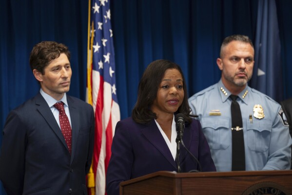 Assistant Attorney General Kristen Clarke of the Justice Department's Civil Rights Division, flanked by Minneapolis Mayor Jacob Frey, left, and Chief Brian O'Hara of the Minneapolis Police Department, speaks at a news conference after the Minneapolis City Council approved a settlement agreement with the U.S. Department of Justice approving a federal consent decree, at the U.S. Courthouse in Minneapolis, Monday, Jan. 6, 2025. (Jeff Wheeler/Star Tribune via AP)