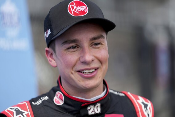 Christopher Bell talks after winning the pole during qualifications for a NASCAR Cup Series auto race at Michigan International Speedway in Brooklyn, Mich., Saturday, Aug. 5, 2023. (AP Photo/Paul Sancya)