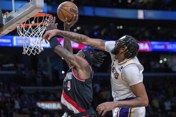 Portland Trail Blazers forward Jerami Grant, left, shoots the game-winning shot against Los Angeles Lakers forward Anthony Davis during the second half of an NBA basketball game Sunday, Oct. 23, 2022, in Los Angeles. (AP Photo/Alex Gallardo)
